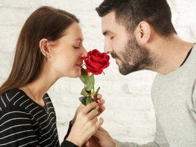 man and woman smelling a rose after covid recovery
