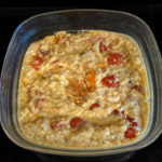 cheese tomato and feta dip in baking dish with black background