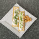 gluten free herbed crackers on a white plate with dip