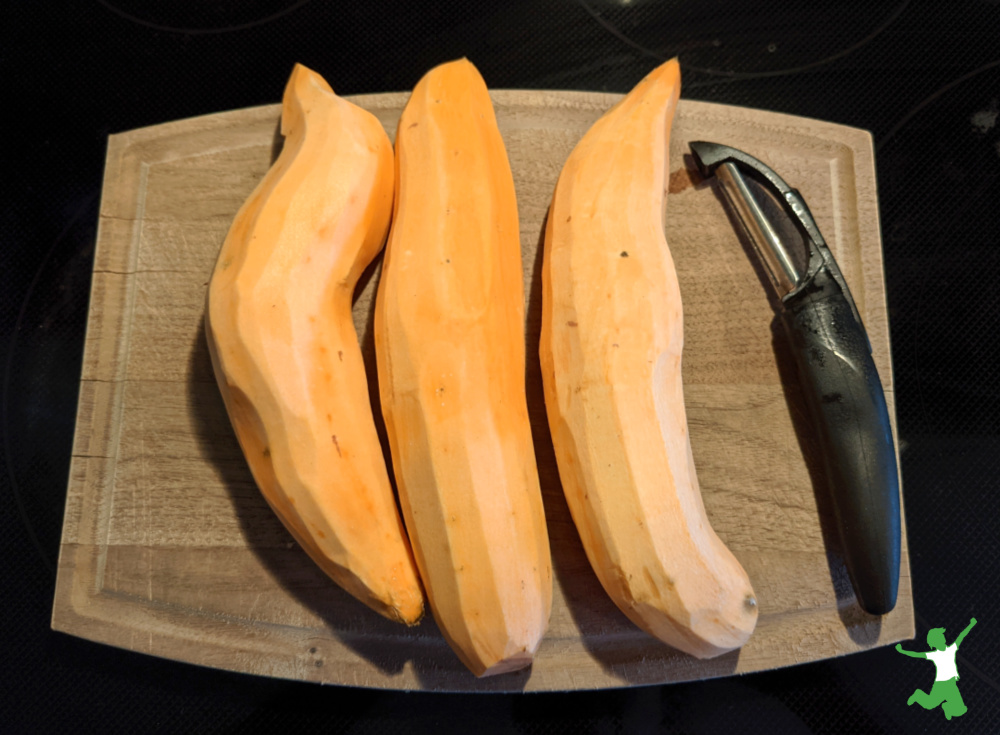 washed and peeled Jewel sweet potatoes on a cutting board