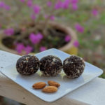 almond chocolate energy balls on a white plate