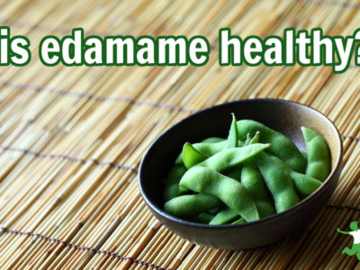 boiled edamame in a bowl on bamboo mat