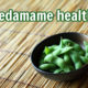 boiled edamame in a bowl on bamboo mat