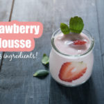 healthy strawberry mousse in a glass with wooden background