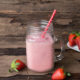 coconut milk strawberry banana smoothie in a mason jar with straw