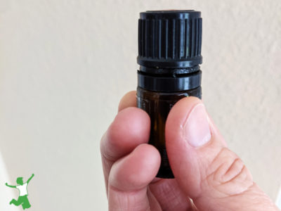 woman holding a bottle of essential oil