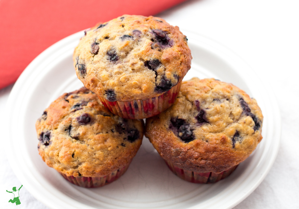 three healthy grain free blueberry muffins on white plate