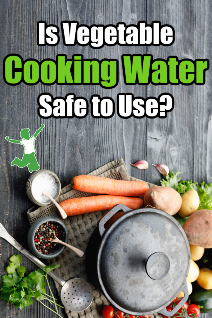 vegetables around a cooking pot with water on wooden background