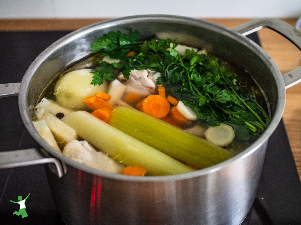 large pot of chopped vegetables and cooking water on a stovetop