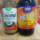 bottles of liquid coconut oil and mct oil on wooden table