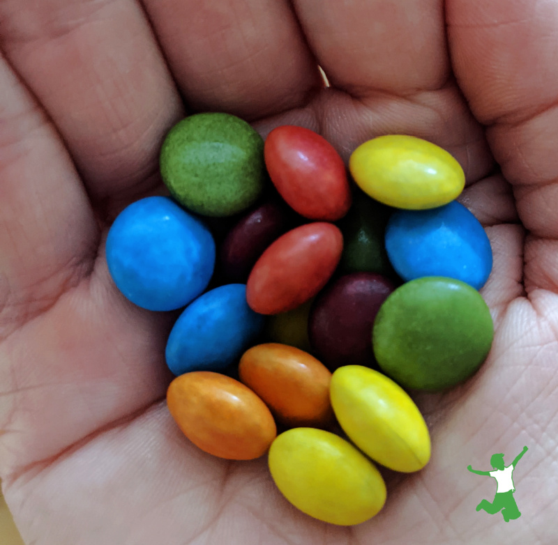 naturally colored chocolate candies in a woman's hand