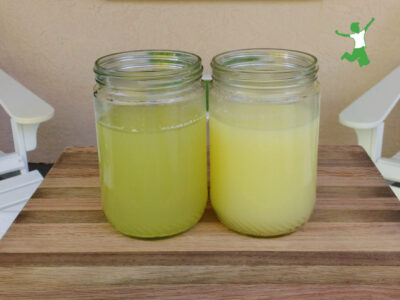 strained and unstrained whey in jars on wooden board