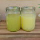 strained and unstrained whey in jars on wooden board