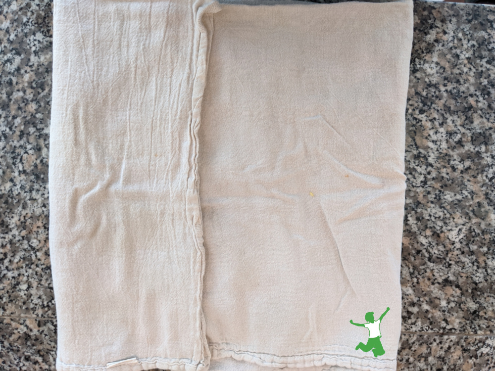 oregano on a granite counter with white towel folded over