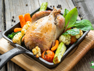 roast pheasant with vegetables on wood cutting board