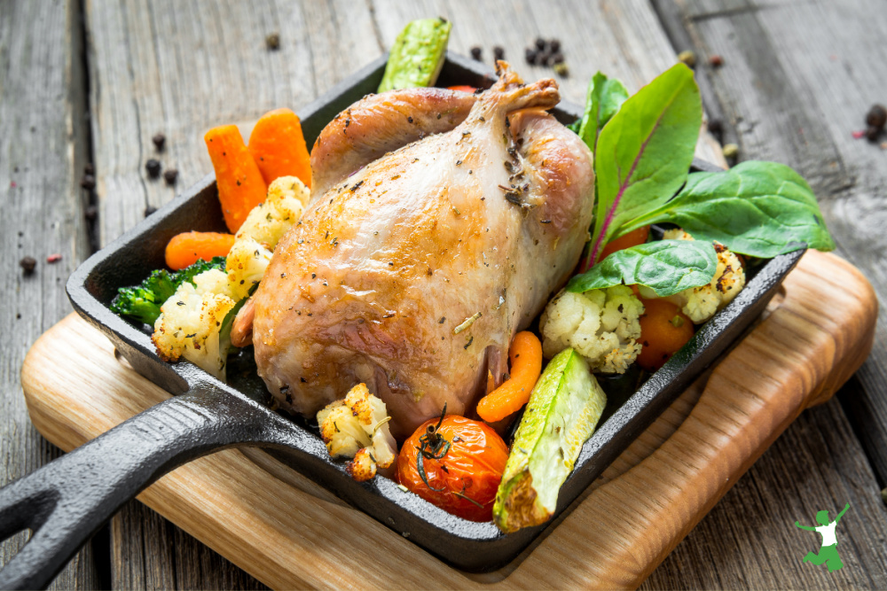 roast pheasant and vegetables on cast iron skillet