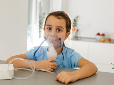 young girl using a nebulizer with hydrogen peroxide