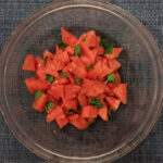 fermented watermelon and mint salad in glass serving bowl