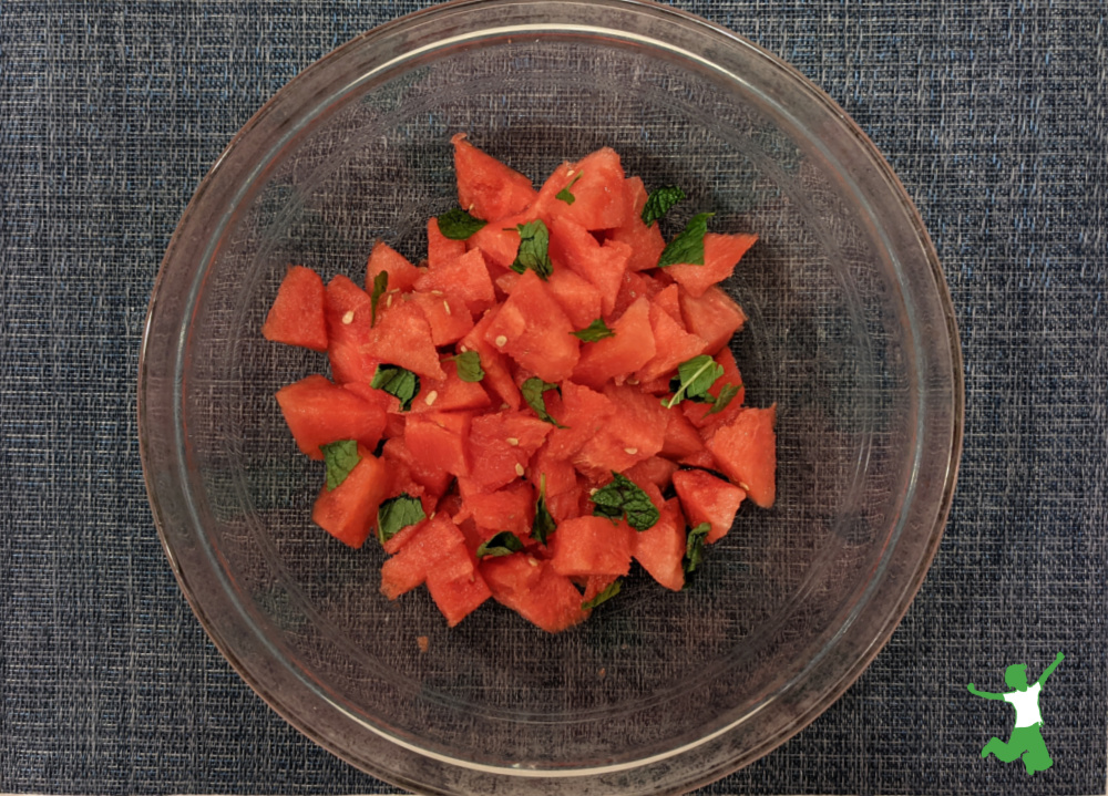 cultured watermelon salad with mint leaves in glass bowl