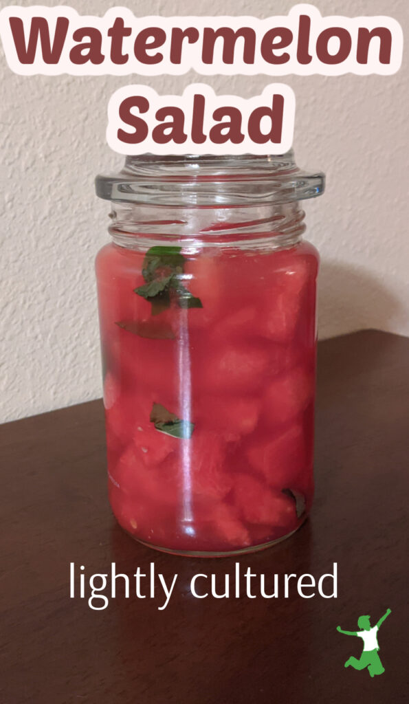 fermenting watermelon in a mason jar with mint leaves