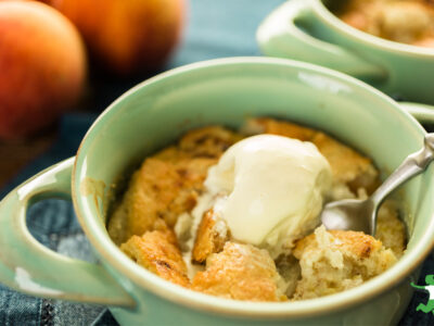 healthy grain free peach cobbler with scoop of vanilla ice cream