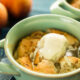 healthy grain free peach cobbler with scoop of vanilla ice cream