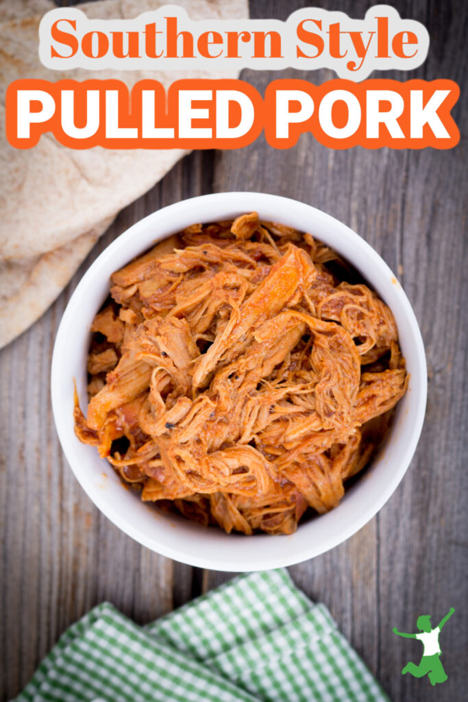 southern pulled pork in white bowl with wooden background