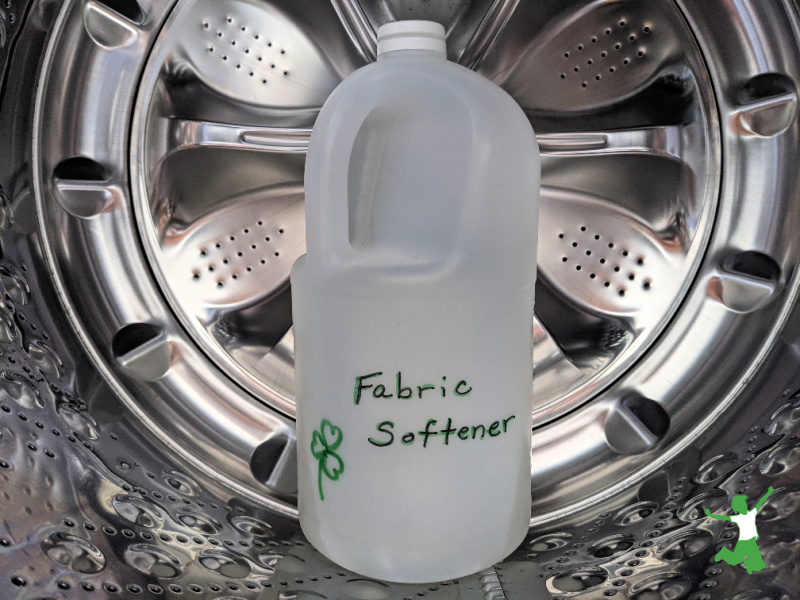bottle of homemade fabric softener inside washing machine