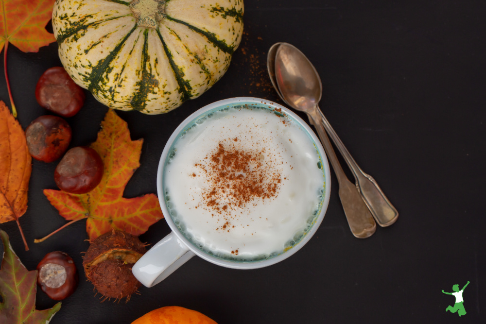 pumpkin spice latte with seasonal background and spoons