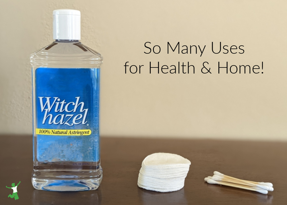 bottle of witch hazel with cotton pads on wood table