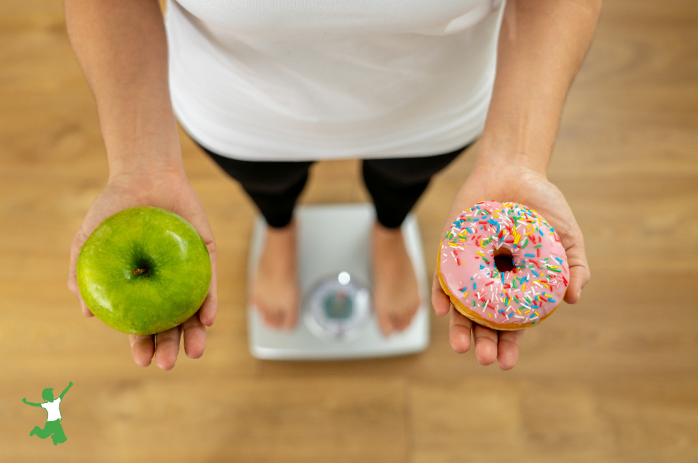 woman with nonalcoholic fatty liver disease standing on scale holding donuts