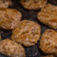 homemade sausage patties cooking in a pan