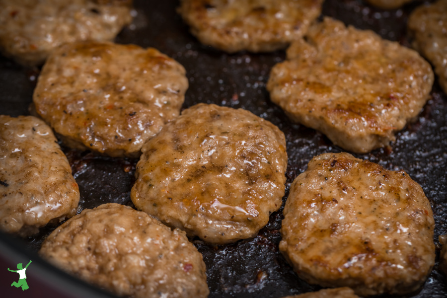 sugar-free homemade sausage sizzling in a pan