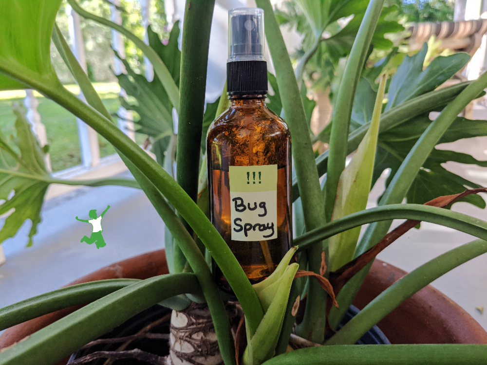 homemade insect repellent spray in amber bottle natural background