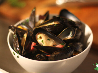 mussels and sausage in white bowl