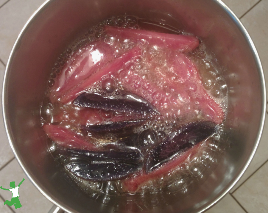 purple potato french fries cooking in a pan on the stovetop