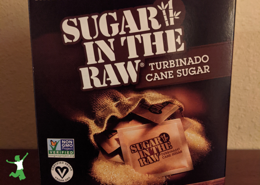 box of sugar in the raw packets on wooden table