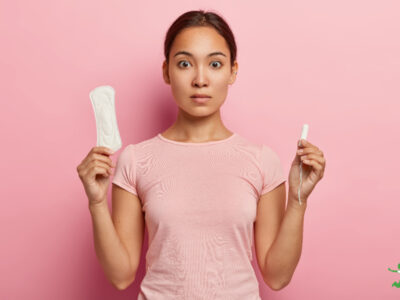 woman holding toxic tampon and pad