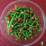 green bean and tomato Christmas salad in glass bowl