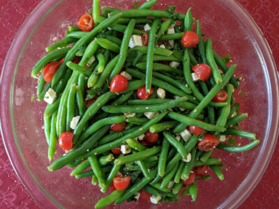 green bean and tomato Christmas salad in glass bowl