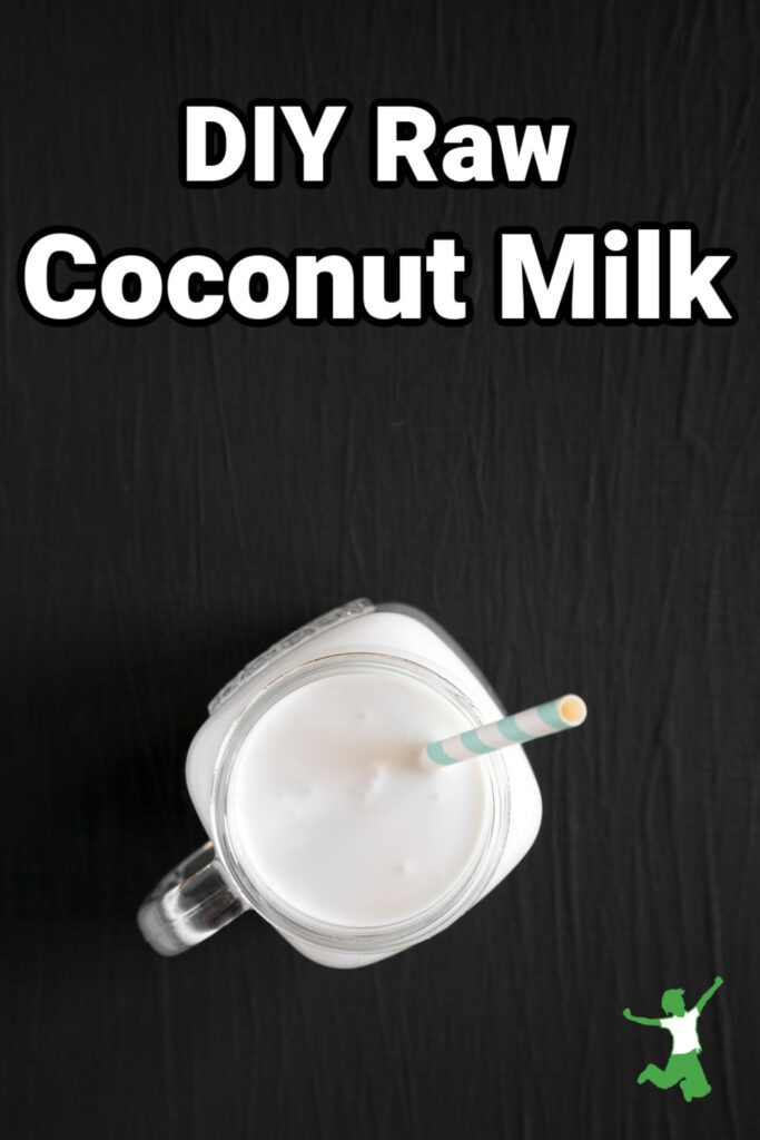 glass mug of raw coconut milk with a straw