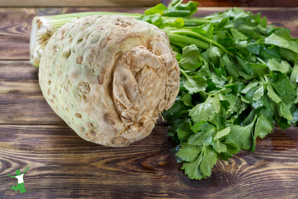 celeriac with greens as white potato substitute on wooden counter