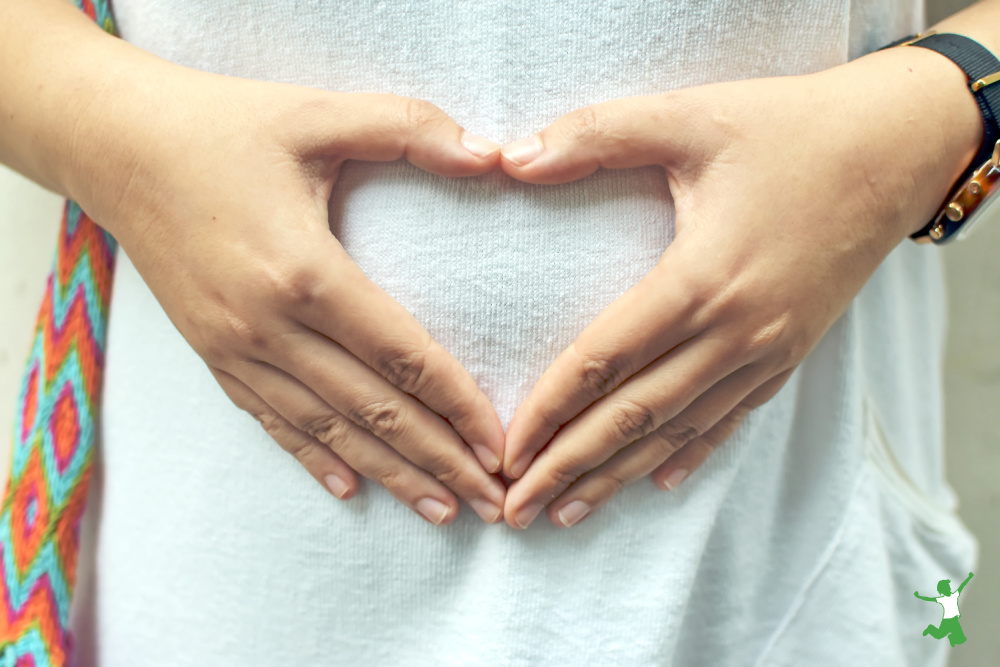 woman with healthy gut from taking prebiotics and prebiotic foods