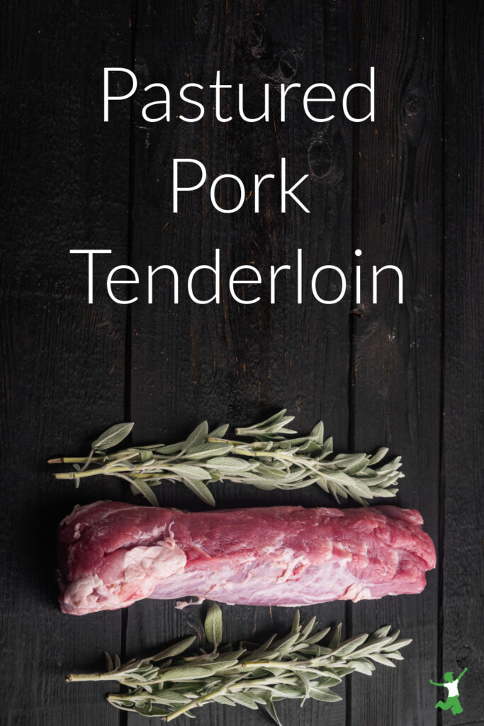 pastured pork tenderloin with rosemary sprigs wooden background