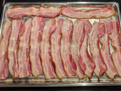 bacon strips in a pan cooked hands-free