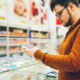 man reading meat label for antibiotic-free