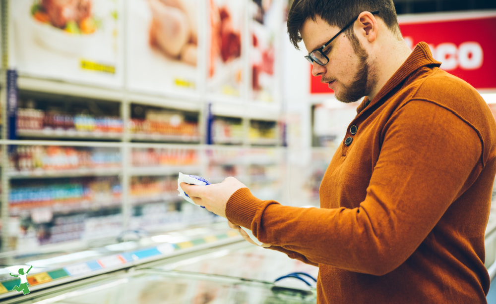 man examining food label to identify antibiotic-free meat