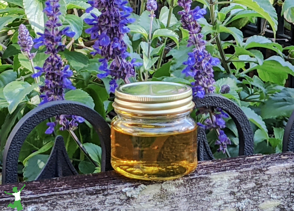 neutral taste coconut ghee in small jar purple flower background