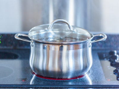 pot of cumulative time bone broth simmering on stovetop