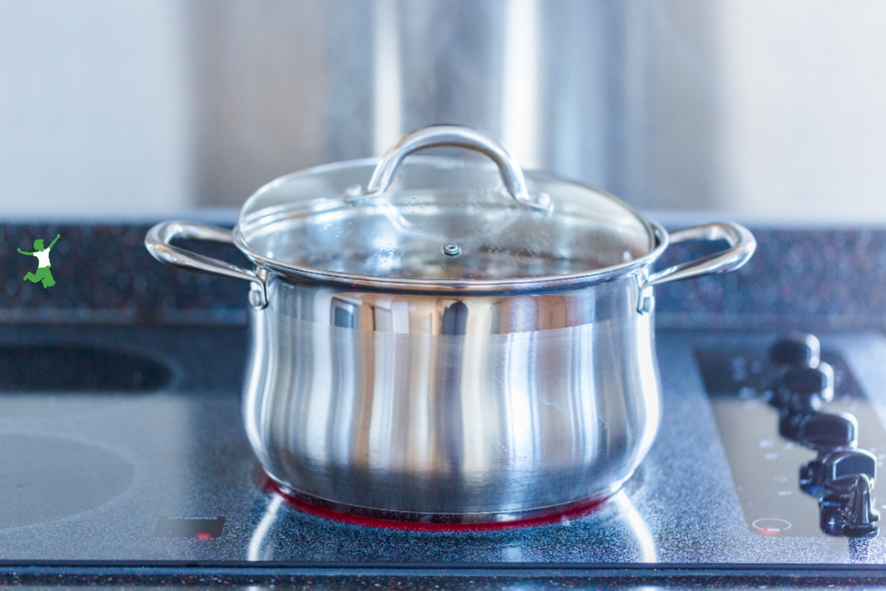 pot of cumulative time bone broth simmering on stovetop